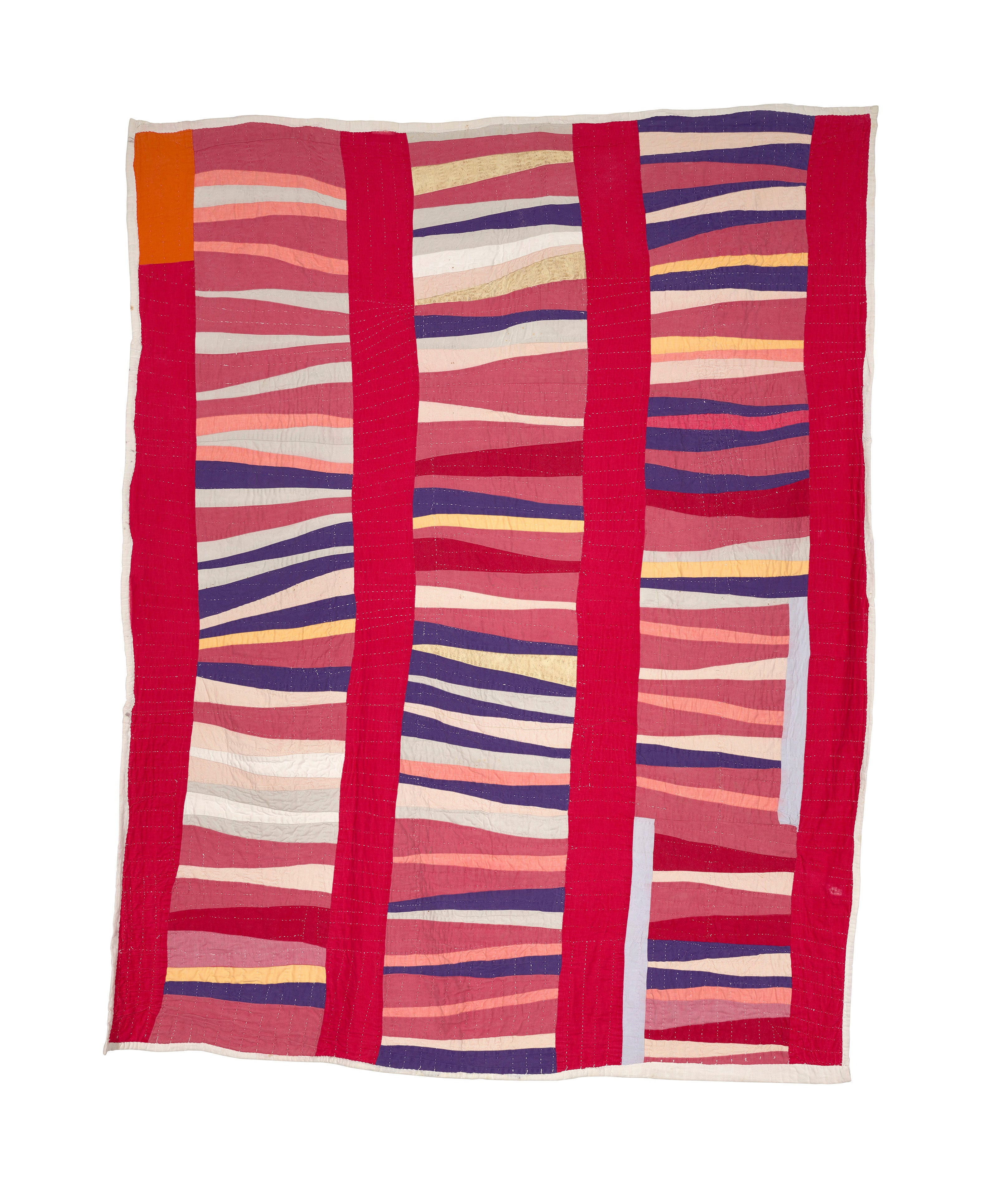 Geometric quilt in red, blue, orange, yellow, pink, and white