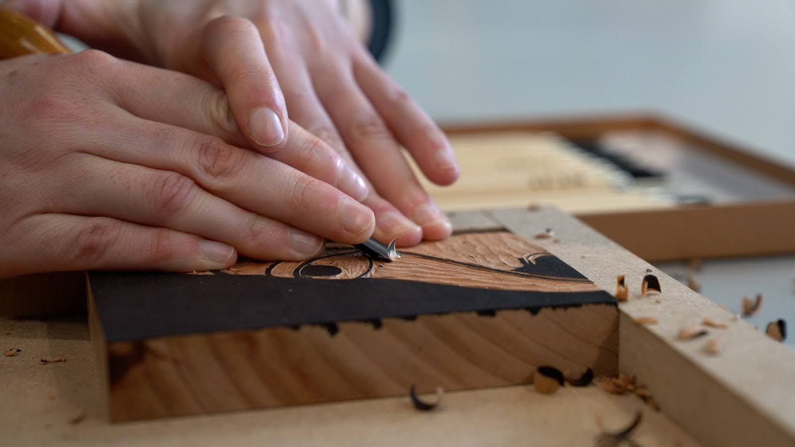 Hands carving a woodblock